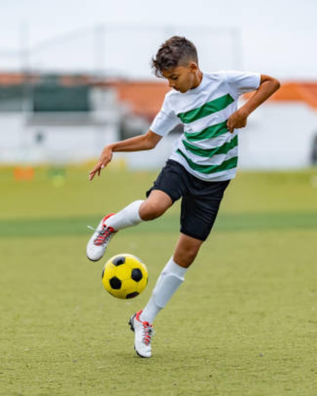 Young athlete kicking a football